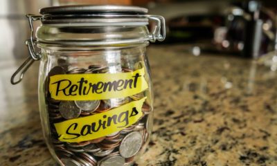 Retirement Savings Money Jar. A clear glass jar filed with coins and bills | 7 Tips to Help You Boost Your Retirement Savings | featured