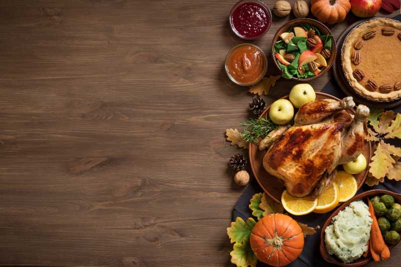 Thanksgiving dinner background with turkey and all sides dishes-Thanksgiving