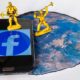 Two toy workers simulate the destruction of the Social Network Facebook on a smartphone | Upcoming Facebook Rebrand Includes Changing Its Name | featured