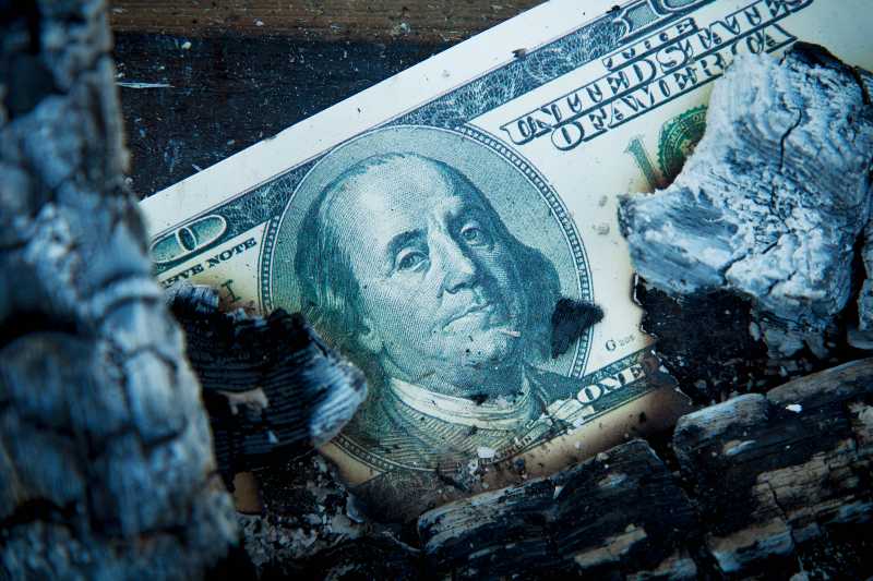 Burning US Dollar bill as a symbol of inflation-US Inflation