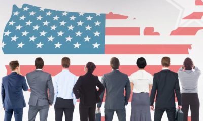 Digital composition of business people looking at American flag | The 4 Hottest Careers in the US This 2020 | featured