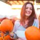 Fashionable beautiful young girl at the autumn pumpkin patch background | How Does The Stock Market Perform During Thanksgiving Week? | featured
