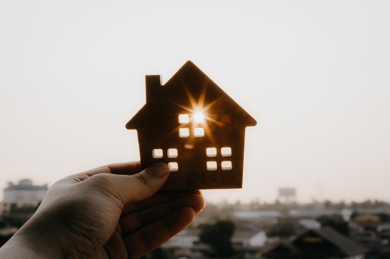 House model in homes insurance broker agent ‘s hand-Affordable Housing