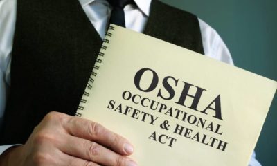 OSHA Occupational Safety & Health Act in the hands | OSHA Suspends Biden’s Large Employer Vaccine Mandate | featured