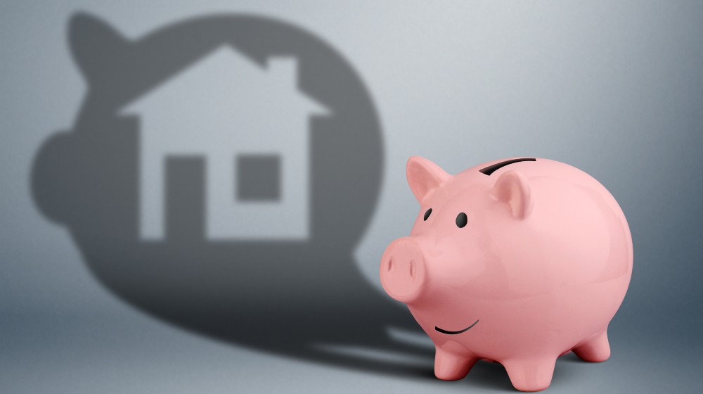 Pink piggy bank with shadow as home, savings for house finance concept | Total US Household Debt Reaches $15 Trillion For The 1st Time | featured