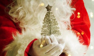 Santa Holding Christmas Tree | Supply Chain Crisis Makes Auto Firms Ditch Holiday Promos | featured