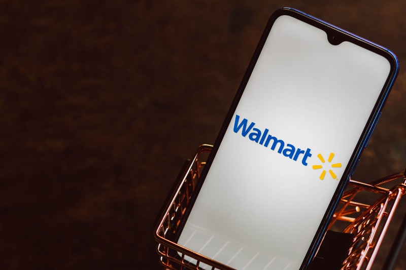 Walmart logo displayed on a smartphone along with a shopping cart-Walmart's Black Friday