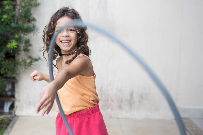 girl playing hula hoop on her arm-Effects On Children