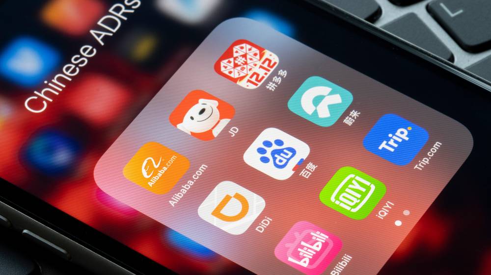 App icons of assorted Chinese companies that trade on US stock exchanges | Chinese Firms Will Likely Delist From US Stock Markets By 2024 | featured