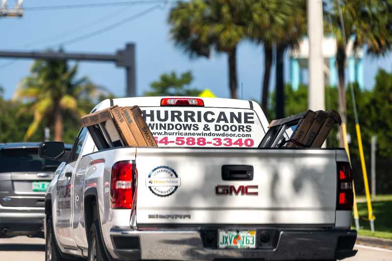 Hurricane windows and doors advertisement sign on truck service business company | Hurricanes