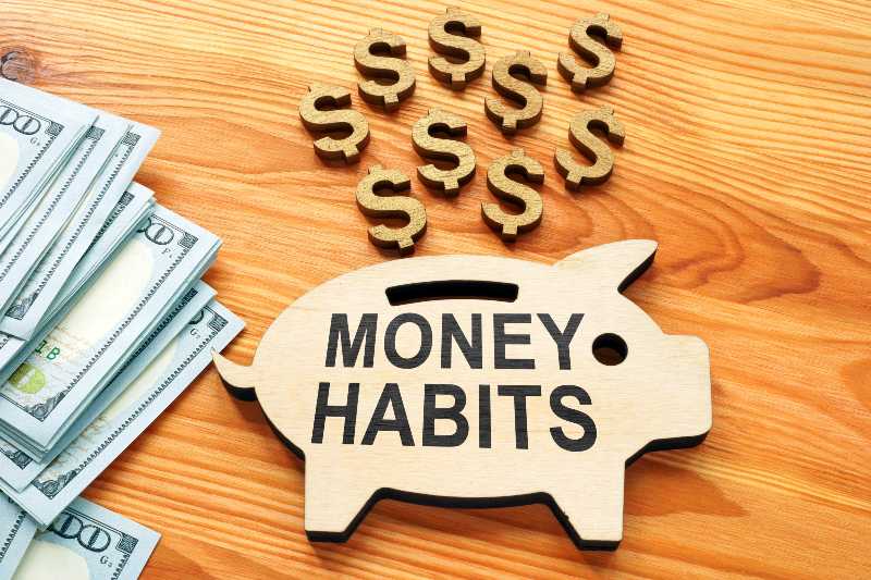 Money habits sign on the wooden piggy bank-Wealth Habits