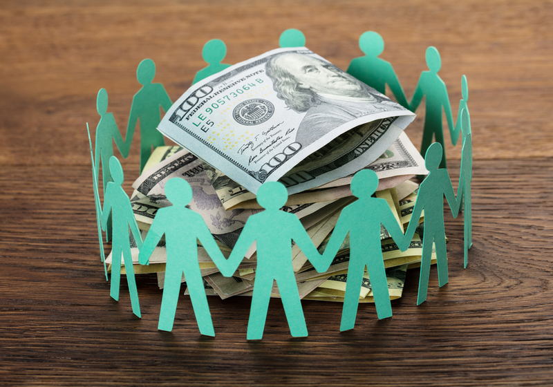 Paper Cut Out Human Figures Around The Stack Of Hundred Dollar Bills | Crowdfunding