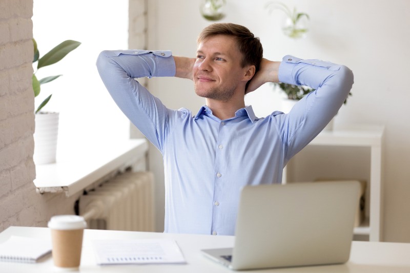 Satisfied businessman relaxing leaning back with hands behind head | 2 Hours in the Morning
