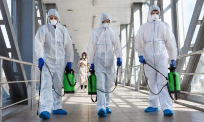 Specialist in hazmat suits cleaning disinfecting coronavirus cells epidemic, pandemic health risk | The Current Phase Of This Pandemic | featured