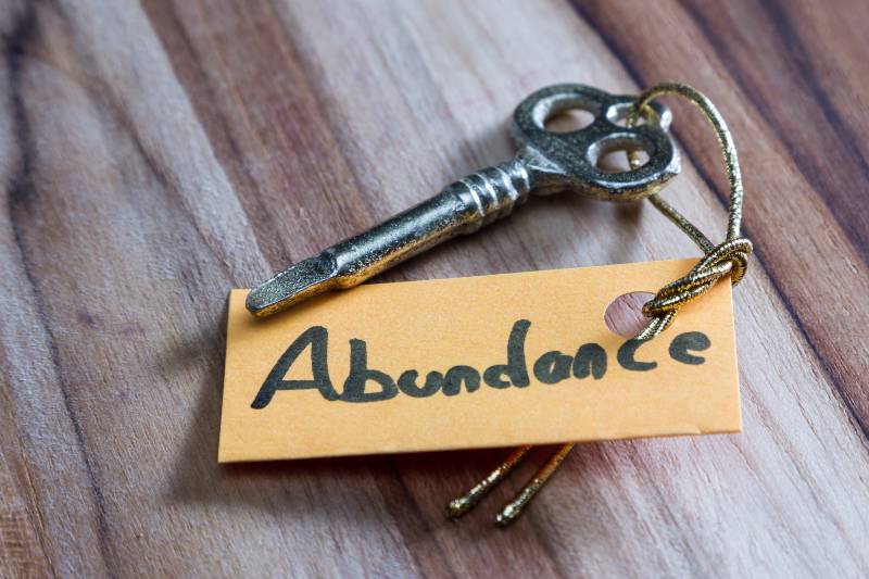concept for a happy abundant life using an old decorative key | Era of Abundance