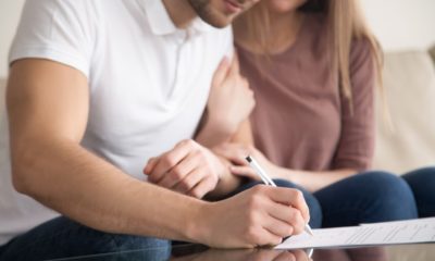 Close up of couple signing documents | American Home Buyers Rushing To Close Deals Before Mortgage Rates Go Higher | featured