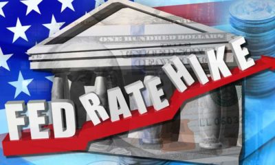 FED RATE HIKE on red arrow overlay with dollar banknote | Federal Reserve Signals Interest Rate Hike This March | featured