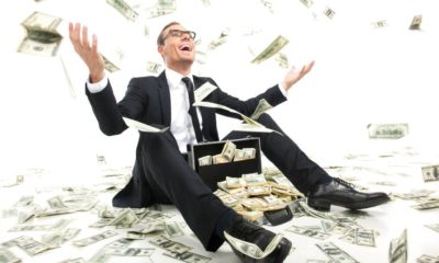 I am rich! Happy young businessman in formalwear throwing money up while sitting | World’s 10 Richest Men Doubled Their Wealth During The Pandemic | featured