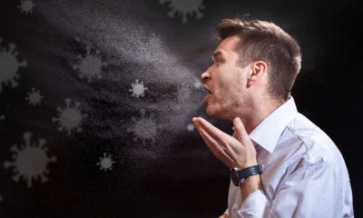 Man is coughing trying to cover his mouth. Influenza, cold, flu, coronavirus | Prior COVID Infection Gave Better Protection Than Vaccines During Delta Surge | featured