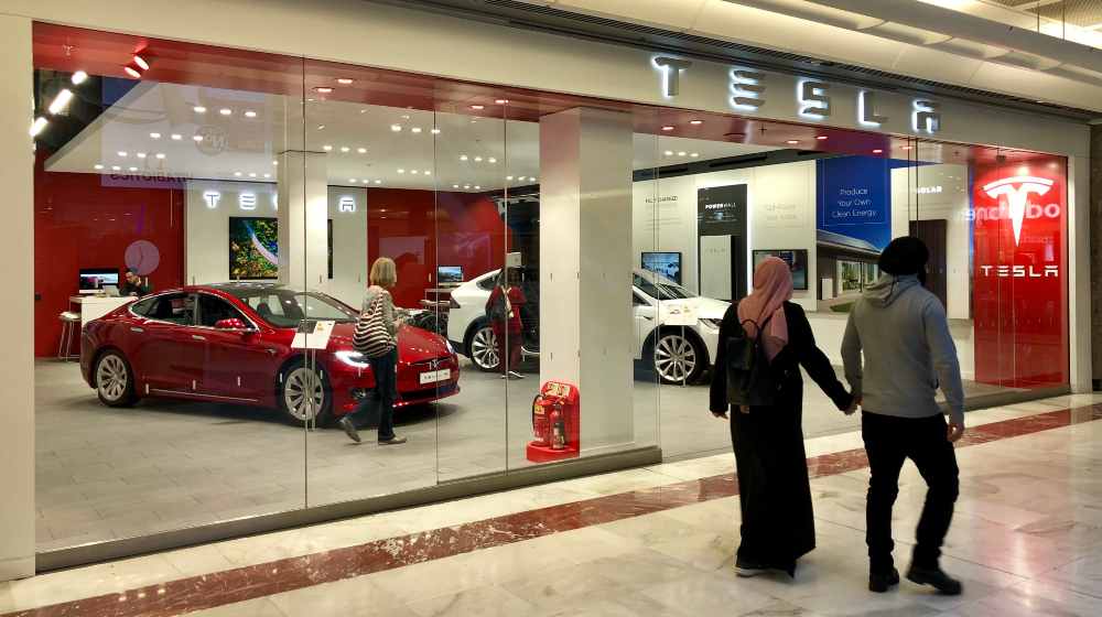Model S and Roadster vehicles on display inside a Tesla Motors Store | Tesla Sales Set Record-Breaking Performances in 2021 | featured