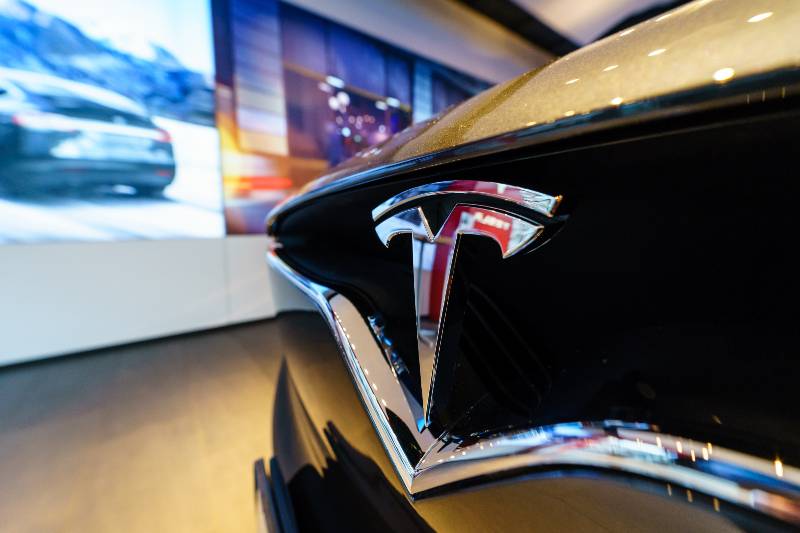 Showroom. The emblem of the full-sized, all-electric, luxury, crossover SUV Tesla Model X | Xinjiang showroom