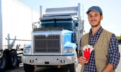 Young truck driver with his truck | 18-Year Olds Now Allowed to Drive Semi Trucks To Help Ease Supply Chain Crisis | featured