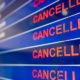 Airport screen indicating cancelled flights | Massive Winter Storm Cancels Thousands of Flights Across US | featured