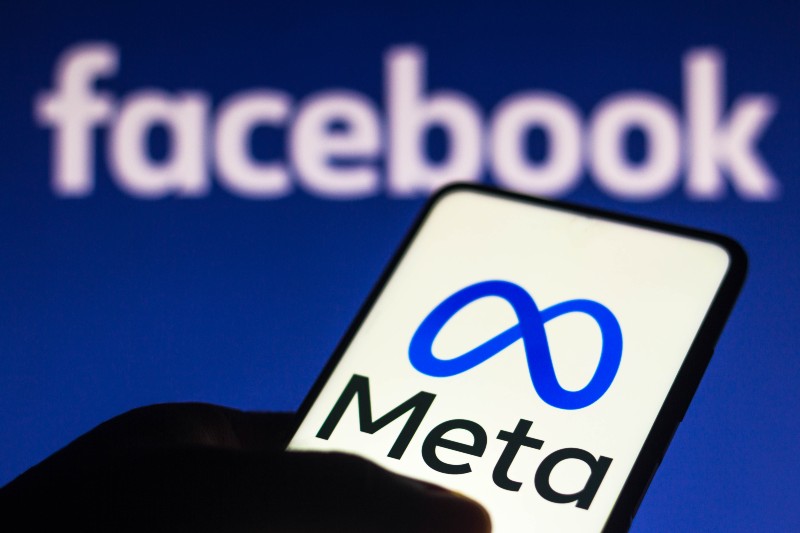 the Meta logo seen displayed on a smartphone and in the background the Facebook logo | Texas Attorney General Ken Paxton Sues Meta 