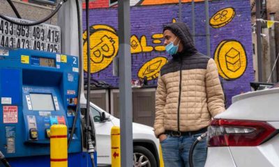 A driver fills up a vehicle's gas tank at a Mobile gas station on 8th Avenue | US Gas Prices Hit New High of $4.43/gal Even As Oil Prices Fall | featured