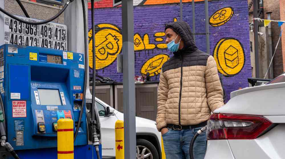 A driver fills up a vehicle's gas tank at a Mobile gas station on 8th Avenue | US Gas Prices Hit New High of $4.43/gal Even As Oil Prices Fall | featured