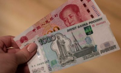 Chinese yuan and Russian ruble banknotes | Russian Firms Rush To Chinese Banks To Open Accounts | featured