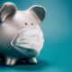Close up of piggy bank, wearing protective face mask | The Biden Administration’s COVID Funding Is Nearly Out | featured