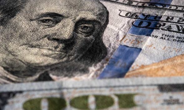 Closeup on Benjamin Franklin portrait on a one hundred US American paper banknote currency | US Recession Looms As Federal Reserve Hikes Interest Rates | featured