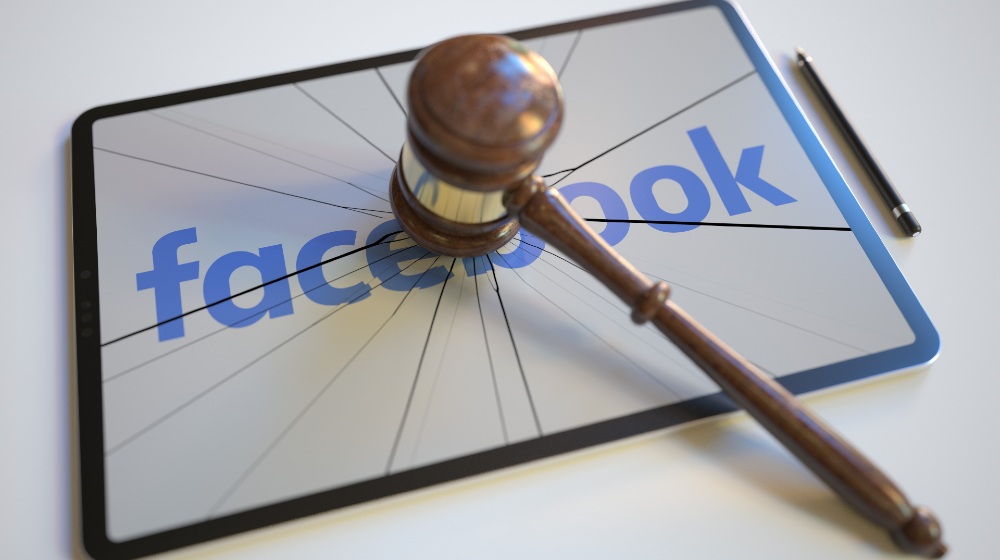 Logo of facebook on the tablet computer screen hit by judge's gavel-Less Time on Facebook-SS-Featured