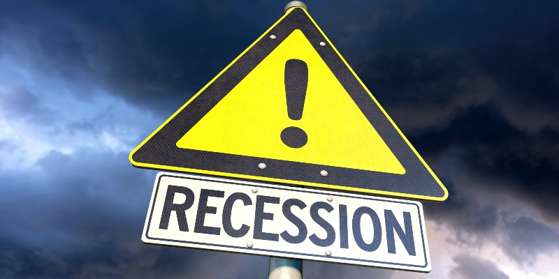 Road sign Recession with threatening sky | US Recession Looms As Federal Reserve Will Raise Interest Rates This March