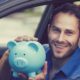 Side view happy man sitting inside his new car holding piggy bank | Democrats Want $100 Monthly Stimulus Checks For Gas | featured