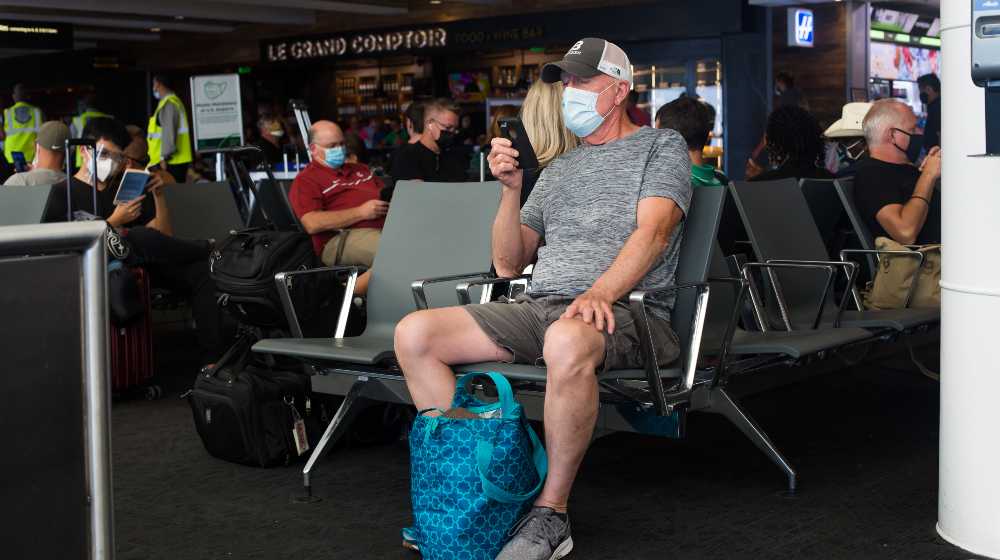 The Seattle airport, terminal C, the passengers waiting for the boarding Alaska airlines | CEOs Urge Biden To End Mask Requirements On Airlines | featured