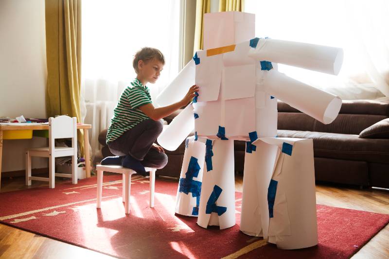 child boy makes a large robot from paper and cardboard | How to Examine Charitable Organizations with Child's Dream Foundation's Marc Jenni