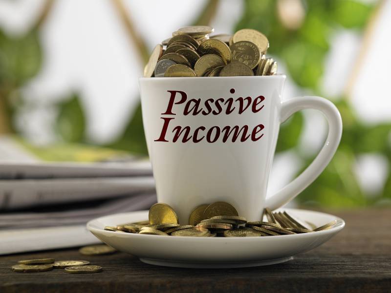 white mug written passive income with coins inside | How To Generate Enough Passive Income to Pay For Your Life w/ Justin Donald