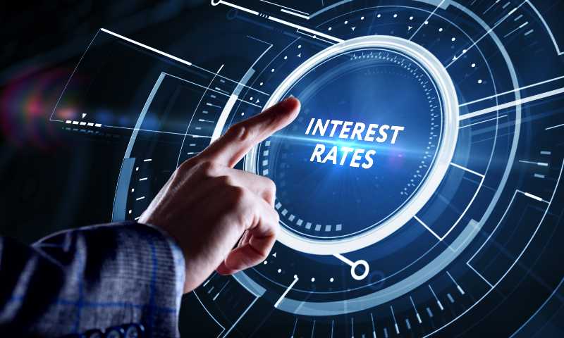 Businessman presses button interest rates on virtual screens | Expect a 50 Basis Points Hike This May