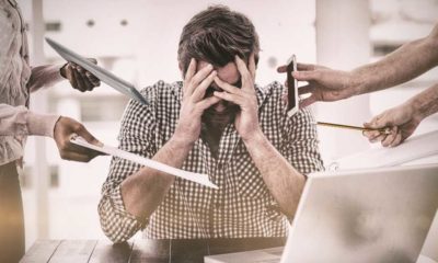 Businessman stressed out at work in casual office | Toxic Work Culture is the #1 Reason Americans Quit Their Jobs | featured