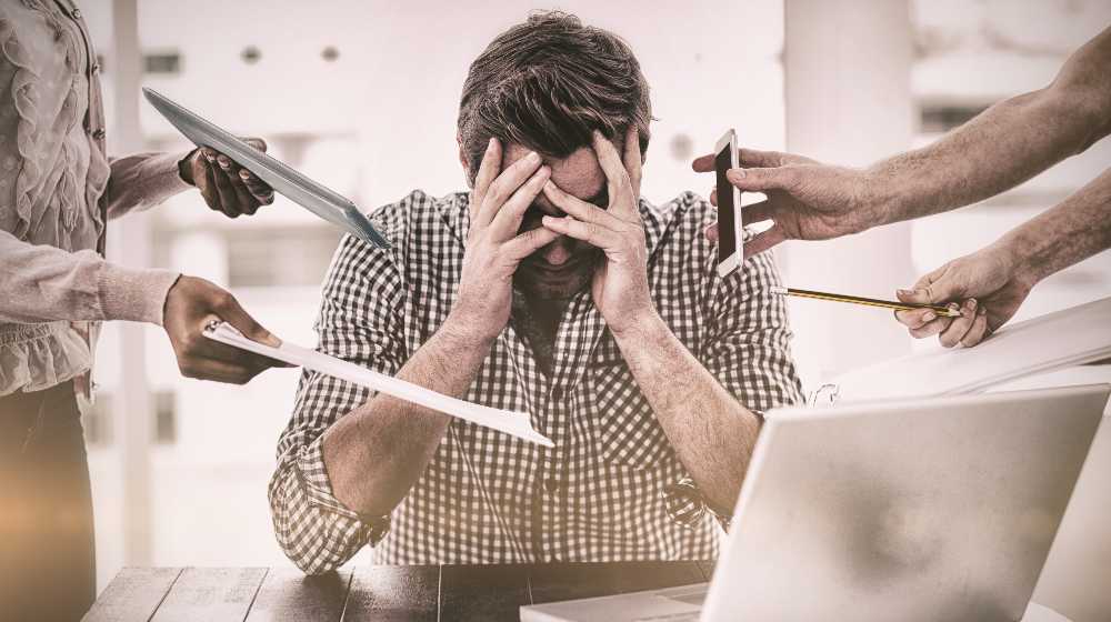 Businessman stressed out at work in casual office | Toxic Work Culture is the #1 Reason Americans Quit Their Jobs | featured