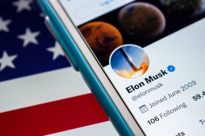Elon Musk twitter account on iPhone on the US flag | Musk Now Largest Shareholder, Is Twitter Takeover Imminent? 