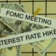 Iinterest rate hike and Fomc meeting on paper with dlooar bank note hang on sieve | Powell Hints At 50 Basis Points Hike In Interest Rates This May | featured