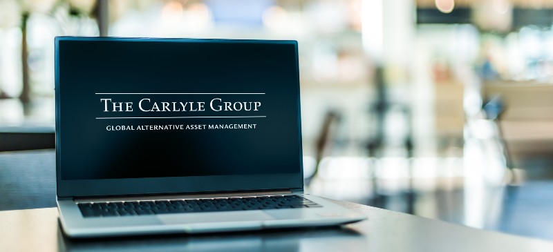 Laptop computer displaying logo of The Carlyle Group | David Rubenstein - Life, Leadership, and LBOs