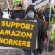 Protestors hold signs and march on a picket line across from Amazon's Whole Foods Market | Amazon Objects To Staten Island Union Election Victory | featured