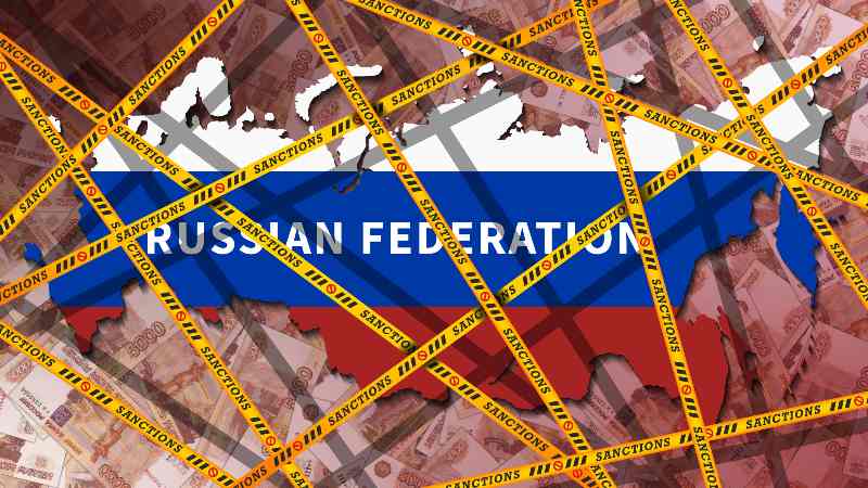 Yellow ribbons with the inscription, sanctions, wrapped around the map of the Russian Federation | More Sanctions Will Increase Russia’s Economic Isolation 