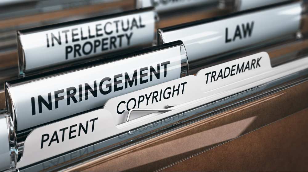 3D illustration of a folder, focus on a tab with the word infringement | US Backs Drive To Waive COVID-19 Vaccines IP Rights | Featured