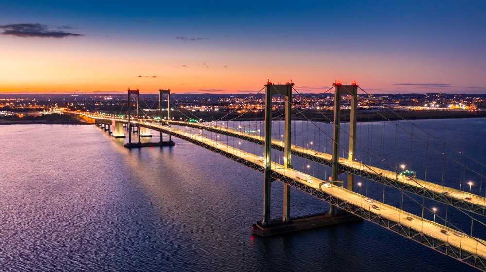 Aerial view of Delaware Memorial Bridge at dusk | House OKs $1T Infrastructure Deal, Wall Street Hits New Highs | featured