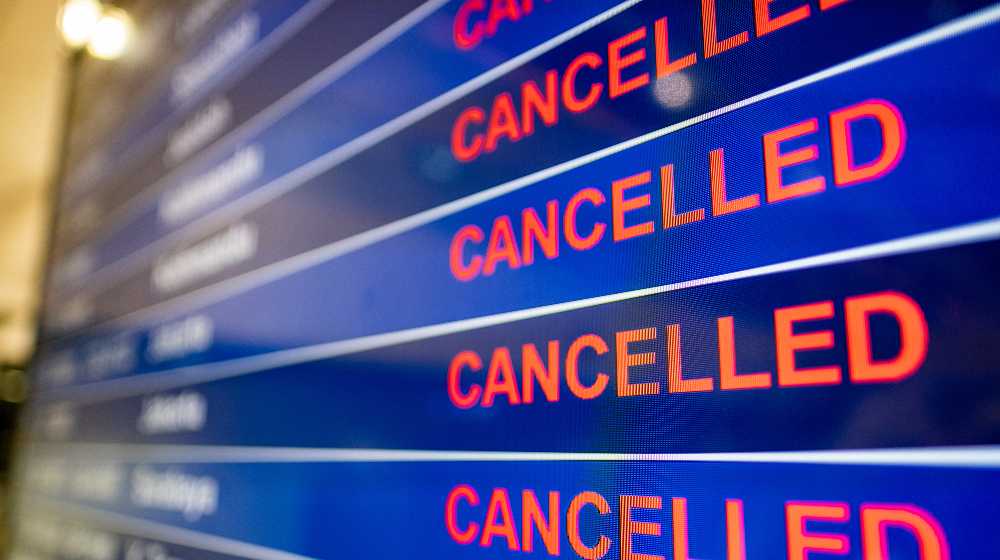 Airport screen indicating cancelled flights | Massive Winter Storm Cancels Thousands of Flights Across US | featured